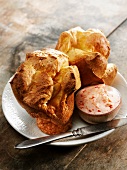 Two Popovers with Strawberry Butter and an Antique Knife on a White Plate
