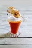 A tomato 'cappuccino' with a scallop skewer