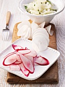 Red and white radishes, sliced, in spirals, and as a salad