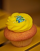 A cupcake topped with lemon buttercream