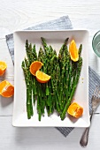 Green asparagus with oranges (view from above)