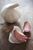 A whole bulb of garlic and two cloves of garlic