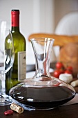 A red wine decanter on a table laid for a meal