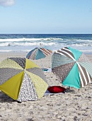 Designer parasols providing shade on sandy seaside beach