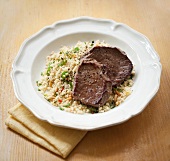 Beef steak on couscous salad
