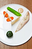 Poached chicken breast with vegetables