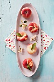 Peaches on a ceramic dish with blossom