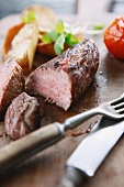 Beef steak and vegetables on a chopping board