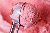 A scoop of home-made strawberry ice cream in an ice-cream scoop