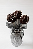 A bunch of chocolate cake pops with sugar pearls