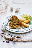 Fish fillet with herb crust and potatoes