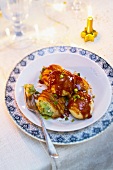 Profiteroles with pistachio and vanilla filling and caramel sauce