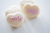 Heart-shaped macaroons decorated with writing using sugar icing