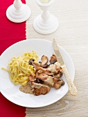 Veal schnitzel with mushroom sauce and ribbon pasta