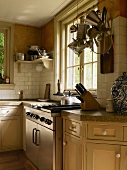 Shaker-style kitchen with stone worksurface and integrated modern cooker block in renovated country house