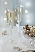 Two glasses of sparkling wine with Christmas decorations