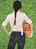 Woman holding terra cotta pots