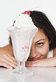 Woman smiling at ice cream sundae