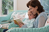 Mother reading to young daughter