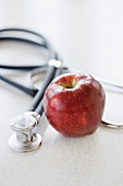 Close up of apple and stethoscope