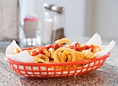 Close up of French fries and ketchup in basket