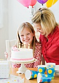 Girl celebrating birthday with mother