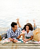 Couple picnicking on dock