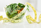 Bowl of salad and tape measure