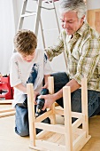 Father and son repairing stool