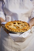 Senior woman holding freshly baked pie
