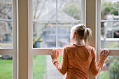 Girl looking out window