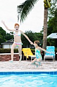 Girls jumping into swimming pool