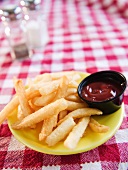 Close up of french fries on checked table cloth