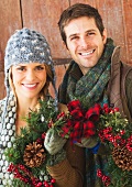 Couple holding christmas wreath