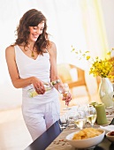 Woman pouring wine to glass