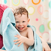 USA, Utah, Lehi, mother with son (2-3) wrapped in towel