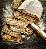 Christmas stollen dusted with icing sugar, partly sliced