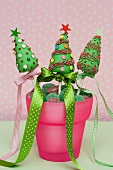 Christmas cake pops in a pot with candies