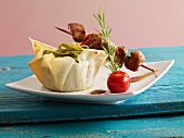 Meat kebabs with green tagliatelle in a phyllo basket