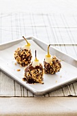 Chocolate covered pears with chopped nuts