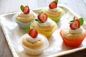 Vanilla cupcakes garnished with strawberries