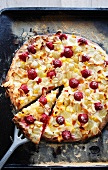 Dessert pizza with raspberries, white currants and almonds