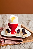 Soft boiled egg with caviar on 'soldiers' (thin toast slices)