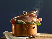 Stewing chicken with vegetables in a copper pot