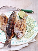 Grilled fish with herb butter and lemon