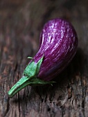 An aubergine on a wooden surface