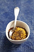 Ground black mustard seeds in a small bowl
