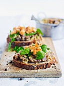 Slices of bread topped with duck rillettes, melon and watercress