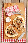 Tarte flambée with sour cream, mushrooms and bacon