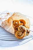 Puff pastry 'pig's ears' in a paper bag